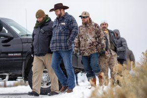 Ammon Bundy, in front, leader of an armed anti-government militia, returns to the Malheur National Wildlife Refuge Headquarters near Burns, Oregon Jan. 5, 2016, following a news conference. The occupation of a wildlife refuge by armed protesters in Oregon reflects a decades-old dispute over land rights in the United States, where local communities have increasingly sought to take back federal land. (Credit: ROB KERR/AFP/Getty Images)