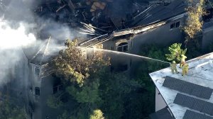 Smoke rises from a Mount Washington home on Oct. 21, 2016. One day after a fire gutted the home. (Credit: KTLA)