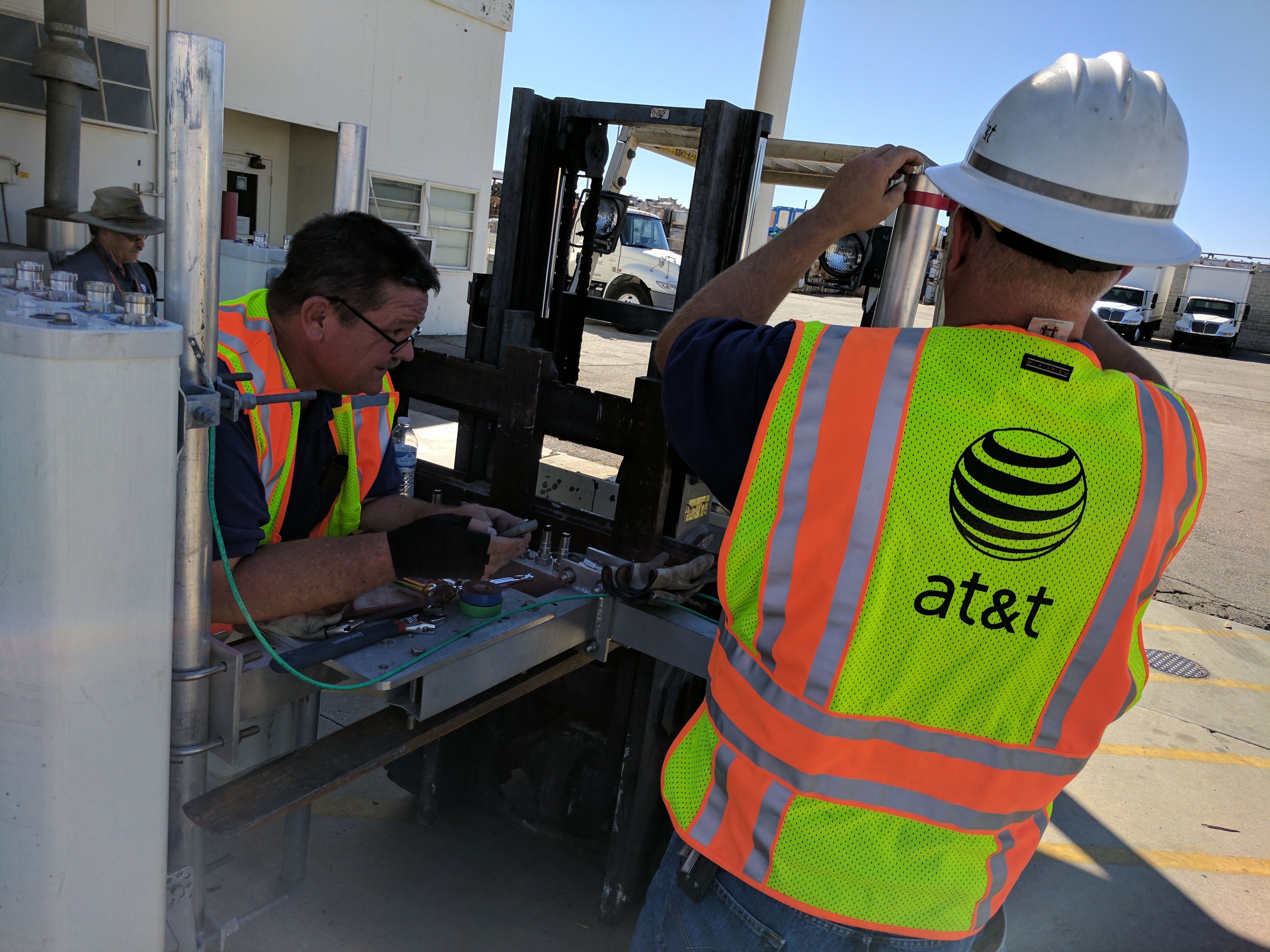 Crews repair a damaged cell tower