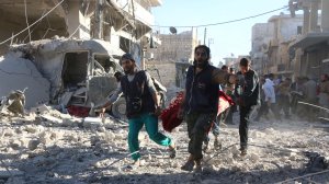 Syrian volunteers carry an injured person on a stretcher following Syrian government forces airstrikes in Aleppo on Sept. 30, 2016. (Credit: Thaer Mohammed/AFP/Getty Images)