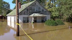 Flood waters rise above the front porch of a home in North Carolina. (Credit: WNCN via CNN)