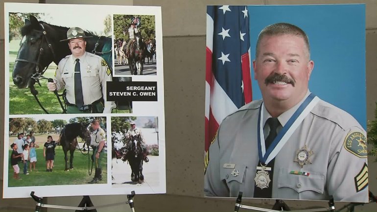 Sgt. Steve Owen is shown in photos displayed outside the sheriff's Lancaster Station on Oct. 6, 2016, a day after he was fatally shot. (Credit: KTLA)