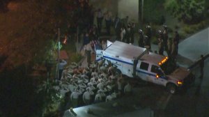 Deputies salute the body of Steve Owen as it is loaded into a coroner's truck on Oct. 5, 2016. (Credit: KTLA)