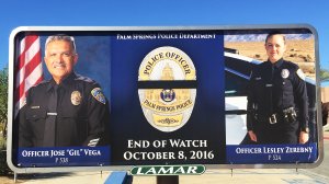 Palm Springs officers Jose "Gil" Vega and Lesley Zerebny are seen in a billboard outside the Palm Springs Convention Center. (Credit: KTLA)