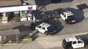 Authorities surround a vehicle that was involved in a police shooting in Torrance on Oct. 31, 2016. (Credit: SHP)