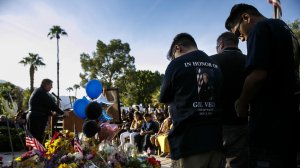 Family members of slain police officers Jose "Gil" Vega bow their heads in prayer as they attend a vigil on Oct. 9, 2016. (Credit: Marcus Yam / Los Angeles Times)