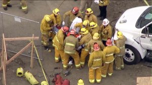 A construction worker was pulled out of a hole after being trapped in Beverly Crest on Oct. 27, 2016. (Credit: KTLA)
