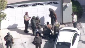 A man is taken into custody in Lancaster after a sergeant was shot on Oct. 5, 2016. (Credit: KTLA)