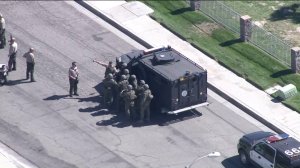 A sheriff's SWAT team responds near where a sergeant was shot in Lancaster on Oct. 5, 2016. (Credit: KTLA)