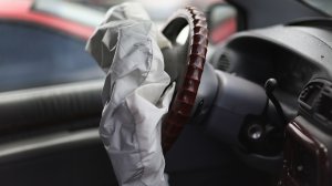 A deployed Takata airbag is seen in a Chrysler vehicle at a salvage yard in Florida on May 22, 2015. (Credit: Joe Raedle/Getty Images)