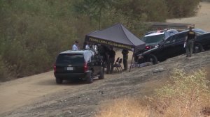 Orange County Sheriff's Department officials investigate a shooting near the Yorba Linda Reservoir on October 3, 2016. (Credit: KTLA) 