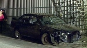 A car crashed off the side of the 405 Freeway on Nov. 29, 2016, falling on top of a homeless encampment. (Credit: KTLA)