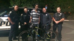 Jourdan Duncan takes a picture with officers and his new bike in an image posted on GoFundMe.