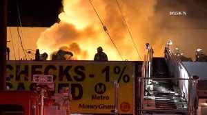 A firefighter was injured while battling a strip mall fire in Canoga Park on Nov. 14, 2016. (Credit: OnScene.TV)