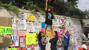 Three young women participated the rally from Mac Arthur Park to downtown Los Angeles on Nov. 12, 2016. (Credit: KTLA) 