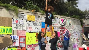 Three young women participated the rally from Mac Arthur Park to downtown Los Angeles on Nov. 12, 2016. (Credit: KTLA)