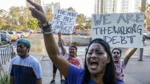 Cal State University Fullerton student Ginny Dolores leads several dozen other Cal State students protesting the possible tuition hike in front of the Cal State University Chancellor's office in Long Beach. (Credit: Mark Boster / Los Angeles Times)