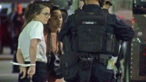 Arrested protesters await placement in a police bus in downtown L.A. early Nov. 11, 2016. (Credit: KTLA)
