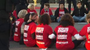 "Fight for 15" protesters sit in the street in downtown Los Angeles on Nov. 29, 2016. (Credit: KTLA)