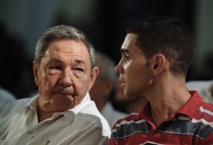 Cuban President Raul Castro, left, talks with Elian Gonzalez on June 30, 2010, in a church of Havana, during the celebration of 10th Anniversary of Elian's return from Miami. (Credit: Adalberto Roque/AFP/Getty Images)