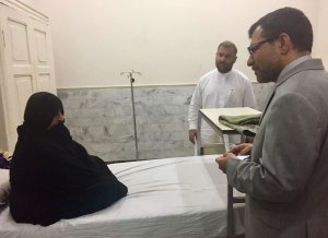 Afghan Consul General in Peshawar Abdul Waheed Poyan (R) talks with Afghan woman Sharbat Gula, known internationally as the 'Afghan Girl' who appeared on the cover of a 1985 edition of National Geographic magazine. (Credit: A MAJEED/AFP/Getty Images)