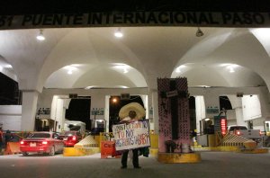 Martin Macias from the Zacatecas state Mexico demonstrates against U.S. Republican presidential candidate Donald Trump at the border crossing between Ciudad Juarez in Mexico and El Paso, Texas, on Nov. 8, 2016. (Credit: Herika Juarez/AFP/Getty Images)