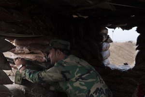 A Peshmerga soldier mans a fortified position along a sand berm north of the Iraqi Kurdish checkpoint village of Shaqouli, east of Mosul, on Nov. 10, 2016. (Credit: Odd Andersen/AFP/Getty Images)