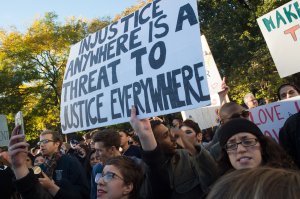 A demonstrator holds up a sign during a "Love Rally" march in New York on Nov. 11, 2016, to protest the election of U.S. President-elect Donald Trump. (Credit: Bryan R. Smith/AFP/Getty Images)