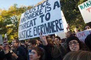 A demonstrator holds up a sign during a "Love Rally" march in New York on Nov. 11, 2016, to protest the election of U.S. President-elect Donald Trump.     (Credit: Bryan R. Smith/AFP/Getty Images)