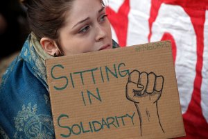 Hundreds of people sit in silent protest against the proposed Dakota Access Pipeline outside the offices of the Army Corps of Engineers Nov. 15, 2016, in Washington, D.C. (Credit: Chip Somodevilla/Getty Images)