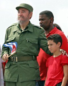 Cuban President Fidel Castro, left, poses with shipwreck survivor Elian Gonzalez, after presiding over a massive May Day demonstration at Havana's Plaza de la Revolucion on May 1, 2005. (Credit: Adalberto Roque/AFP/Getty Images)
