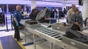 Passengers try out the new automated TSA security checkpoint at LAX on Nov. 18, 2016. (Credit: KTLA)