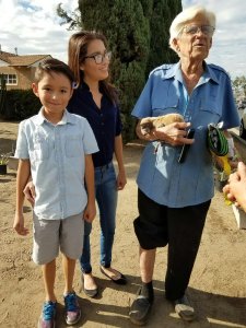 Cynthia Godfrey, center, and her son stand with Roger LeClair and Lola as they are reunited Nov. 19, 2016. (Credit: KTLA)