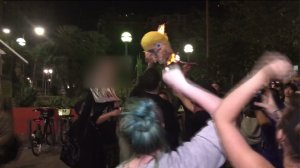 Protesters are seen burning a Donald Trump piñata in downtown Los Angeles in an image provided to KTLA.