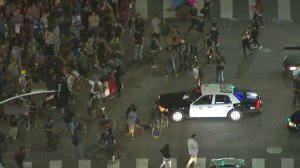 A protest flows around an LAPD vehicle in downtown L.A. on Nov. 10, 2016. (Credit: KTLA)