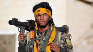 A member of U.S.-backed Kurdish-Arab forces walks 30 miles north of Raqqa on Nov. 6, 2016, as they deploy for an offensive on the Islamic State group's de facto Syrian capital. 