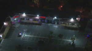 Rialto Police officials cordoned off the scene of a triple shooting on Nov. 18, 2016. (Credit: KTLA)