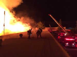 A fire burning in a pallet yard is seen in an image tweeted by the San Bernardino County Fire Department.