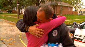 A woman hugs an Urbandale, Iowa, police officer hours after another officer was fatally shot on Nov. 2, 2016. (Credit: KCCI via CNN)