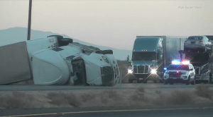 A big rig overturned in gusty winds on Highway 395 in the Pearsonville area on Nov. 16, 2016. (Credit: High Desert News)