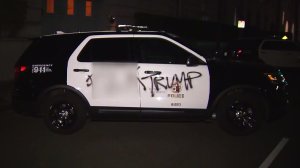 A LAPD patrol vehicle was spray panted with "F--- Trump" during a protest on Nov. 9, 2016. (Credit: KTLA)