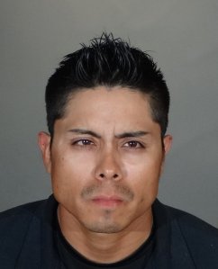 Samuel Alexander Vasquez is seen in a booking photo released by LAPD.