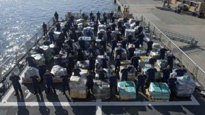 Members of the Coast Guard Cutter Hamilton crew stand next to approximately 26.5 tons of cocaine Dec. 15, 2016 aboard the cutter at Port Everglades Cruiseport in Fort Lauderdale, Florida. (Coast Guard photo by Petty Officer 3rd Class Eric D. Woodall)