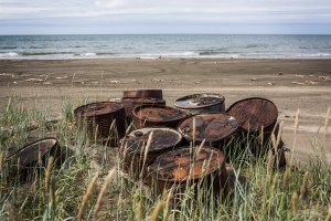 Rusting barrels sit on the beach along the Chukchi Sea on July 7, 2015, in Shishmaref, Alaska. (Credit: Andrew Burton/Getty Images)