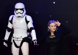 Carrie Fisher poses with a stormtrooper at the opening of the European premier of "Star Wars: The Force Awakens" in central London on Dec. 16, 2015. (Credit: LEON NEAL/AFP/Getty Images)