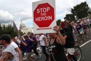 Activists and family members of loved ones who have died from opioid abuse march in a rally at Capitol Hill on Sept. 18, 2016. (Credit: John Moore / Getty Images)