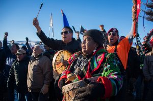 Activists celebrate at Oceti Sakowin Camp on the edge of the Standing Rock Sioux Reservation on Dec. 4, 2016 outside Cannon Ball, North Dakota. The Army Corps of Engineers on Sunday notified the Standing Rock Sioux that the current route for the Dakota Access pipeline will be denied. (Credit: Jim Watson / AFP / Getty Images)
