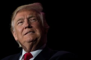 U.S. President-elect Donald Trump looks on while speaking during a rally on his "thank you" tour in Orlando, Florida, on Dec. 16, 2016. (Credit: Jim Watson / AFP / Getty Images)