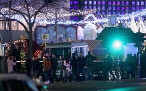 People stand in the area near where a truck plowed through a Christmas market on Dec. 19, 2016, in Berlin, Germany. (Credit: Sean Gallup/Getty Images)