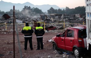 Police officers stand guard on December 21, 2016 at Mexico's biggest fireworks market in Mexico City's Tultepec suburb after a massive explosion killed at least 31 people. (Credit: PEDRO PARDO/AFP/Getty Images)